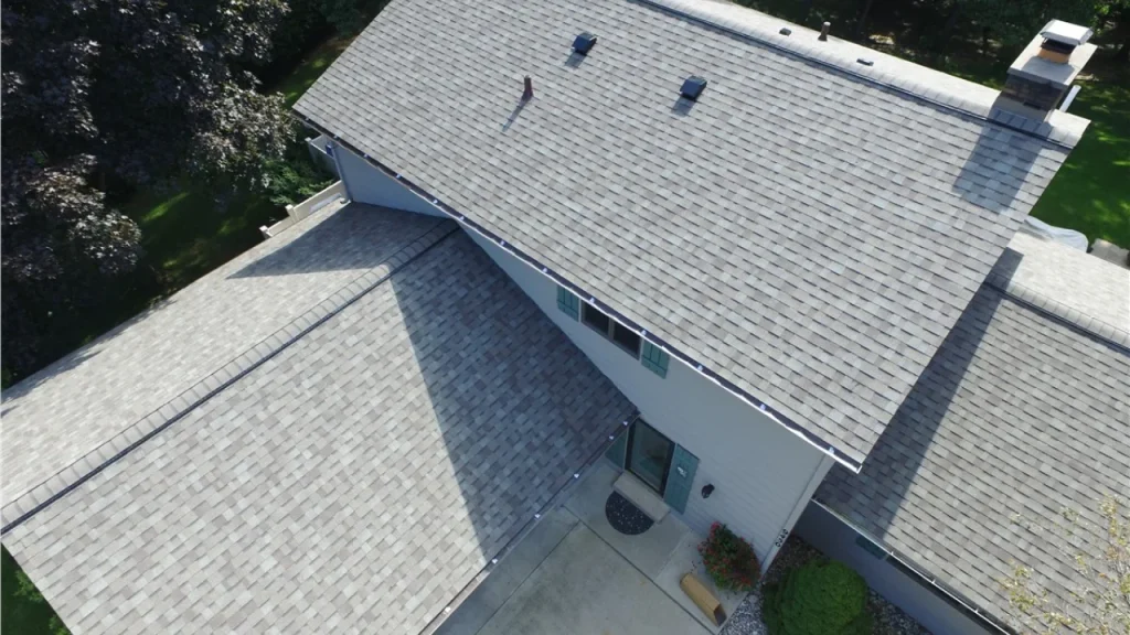 Choosing the Right Gutters for Your Ohio Home’s Roof 4 Ohio homeowner inspecting gutters to choose the best fit for their roof