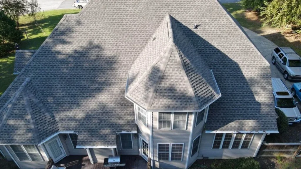 Best Practices for Insulating Your Roof in Indiana to Save on Heating Costs 10 An Ohio homeowner cleaning moss and algae from their roof