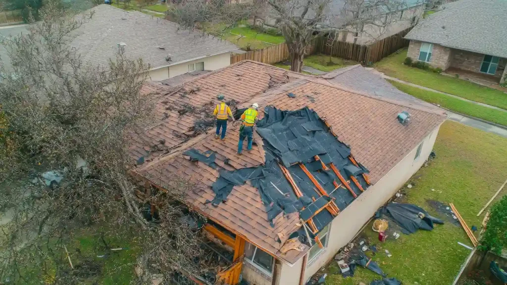 Know what to expect during a new roof installation 7 Roofers installing a new roof with shingles and safety equipment