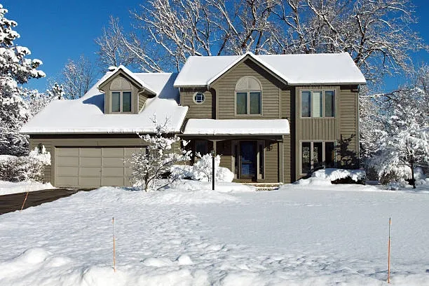 Preventing ice dam roof damage this winter the easy way 8 A snowy Oklahoma roof with ice buildup showing the need for preventing ice dam roof damage.